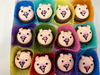 Oreo's with animal face designs in colorful paper liners on a white surface