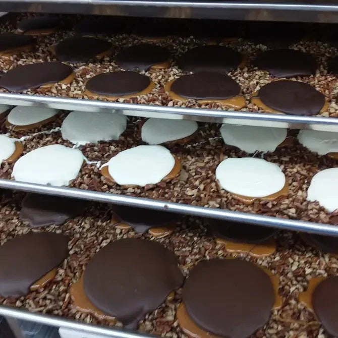 Bear Paws cooling on trays in the Bear Creek Candy Kitchen