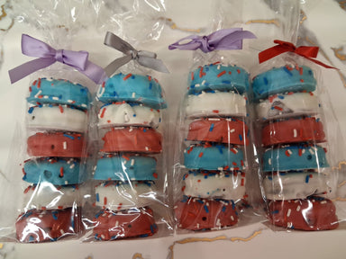 Set of dog collars in red, white, and blue with bows in clear packaging.